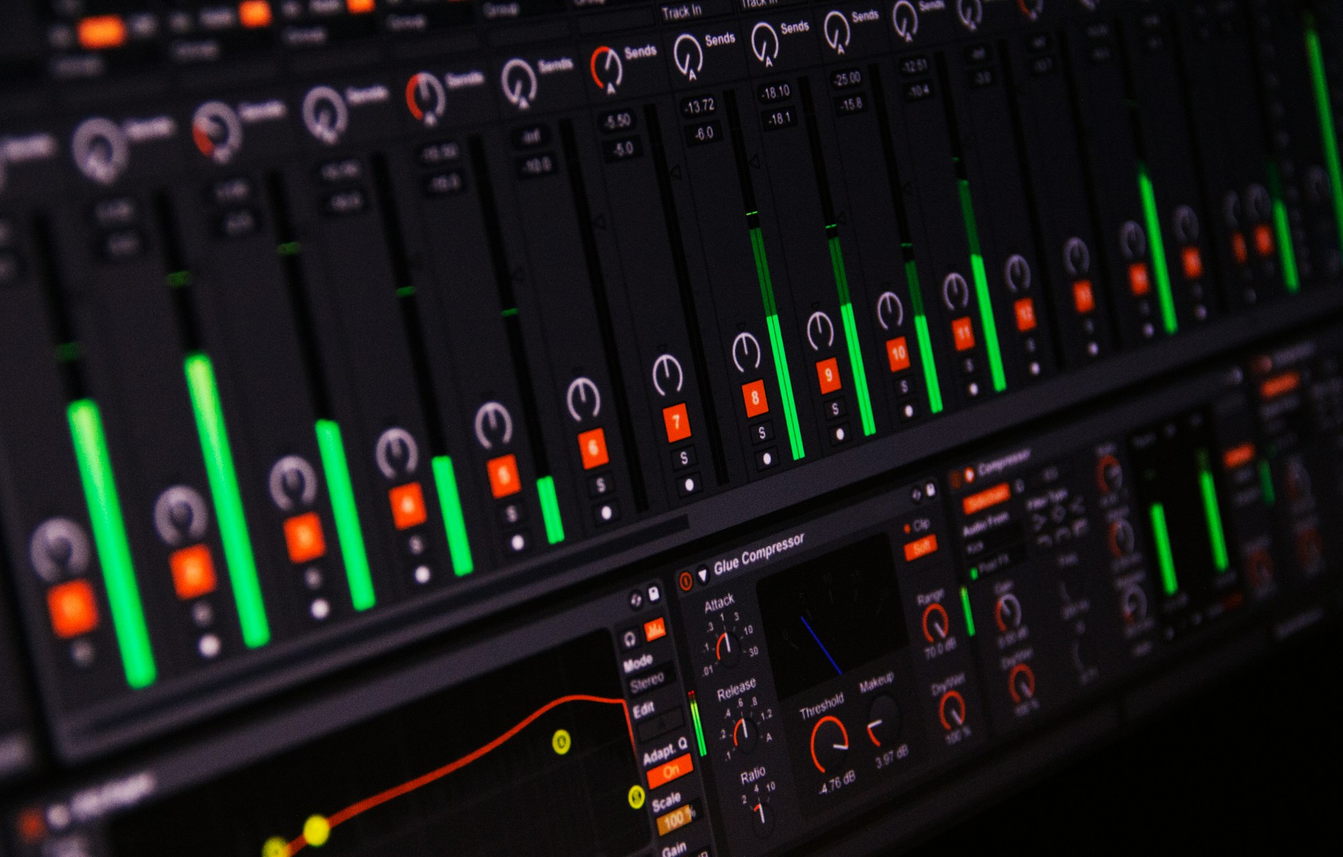 A music production session on screen: channel faders, level meters and a compressor plug-in.