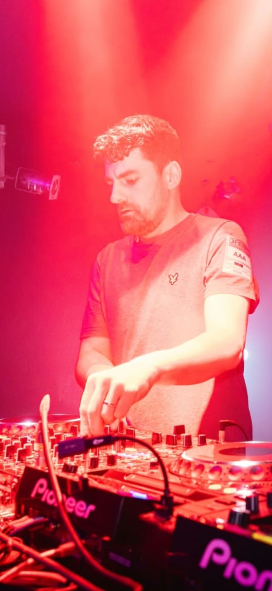 Portrait of Marc Hall playing on Pioneer DJ decks